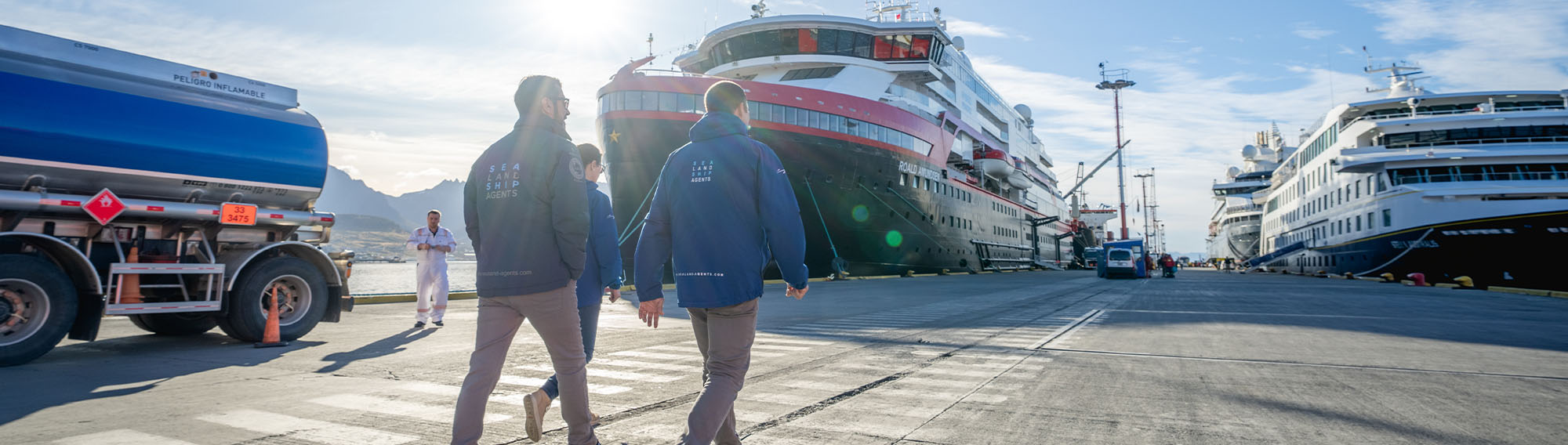 Two Delver Agent team members walking by cruise ship.