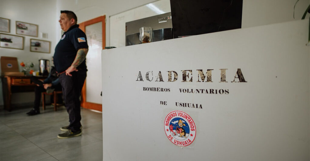 A big sign that says Academia with a firefighter in the background.