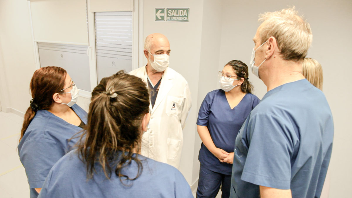 Doctor chatting to his nurses.