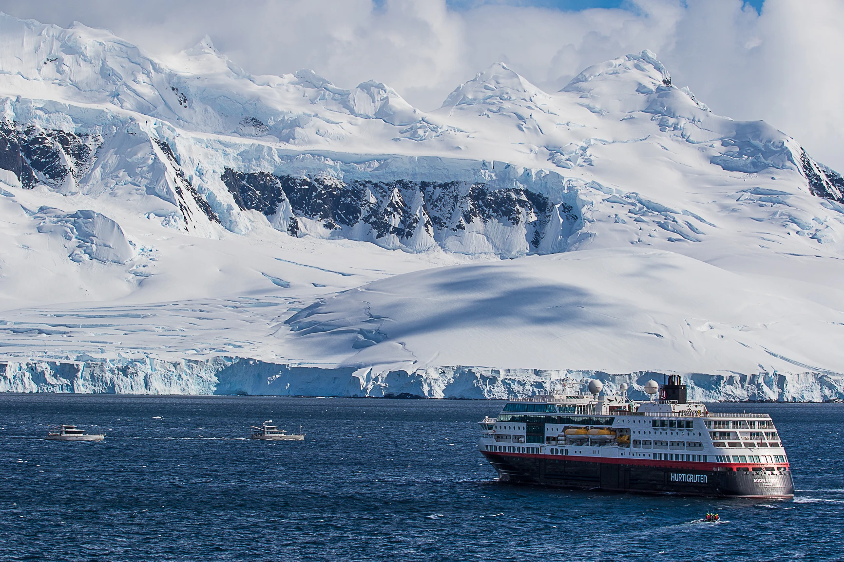 View of a ship with snowy mountains in the background